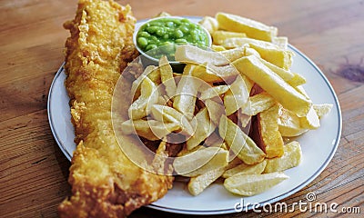 English battered Cod Fish and Chips with Mushy Peas in a plate Stock Photo