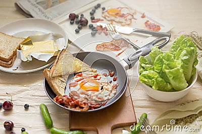 English breakfast - fried egg, bacon, bread blueberry Stock Photo