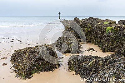 English coastal view, rocks pointing out to sea in Norfolk, UK Stock Photo