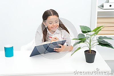 English concept. Little child write English in notebook. Cute girl make English lesson. Pupil do homework in English Stock Photo