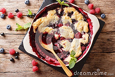 English cuisine: berry cobbler is decorated with mint closeup. Stock Photo