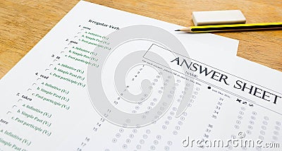 English exercise and answer sheet on brown wooden table Stock Photo