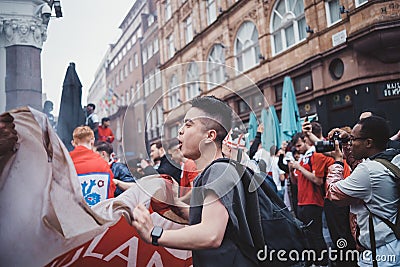 English fans waving flags at Leicester Square before the final Euro 2020 Football game Editorial Stock Photo