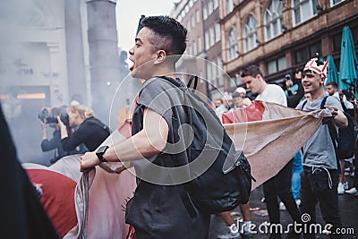 English fans waving flags at Leicester Square before the final Euro 2020 Football game Editorial Stock Photo