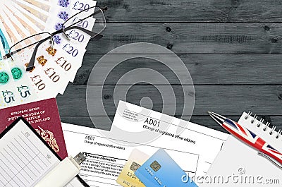 English form AD01 Change of registered office address from Companies House service lies on table with office items. CH business Editorial Stock Photo