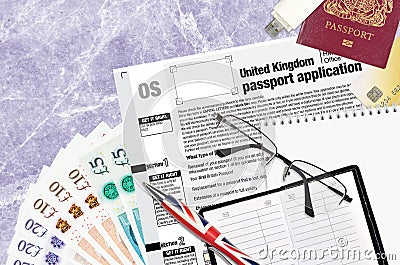 English form OS United Kingdom passport application from HM passport office lies on table with office items. UK passport paperwork Editorial Stock Photo