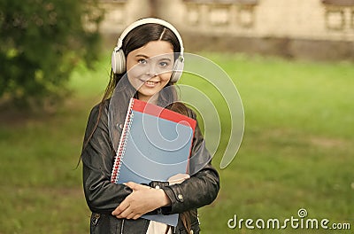 English learning courses. Happy girl learn English. Little child hold English books. Listening comprehension skills Stock Photo