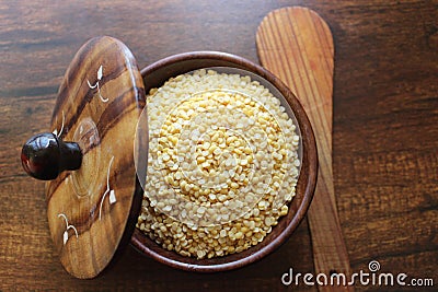 Yellow Moong dal in wooden bowl Stock Photo