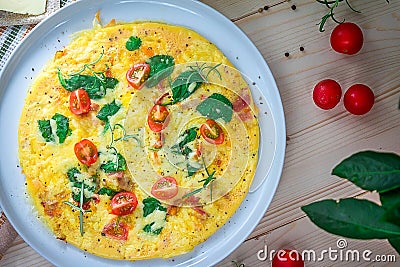 English Omelette with Butter and Tomatoes on Table Stock Photo