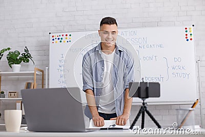 English online from home. Happy guy looks at webcam and answers on questions Stock Photo