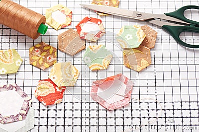 English paper pieced hexagons on white craft mat Stock Photo