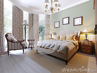 English-style bedroom with a large soft fabric bed. bedside tables with lamps. Large wardrobe and dresser with mirror Stock Photo