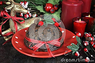 English style Christmas Plum Pudding dessert with traditional festive decorations close up. Stock Photo