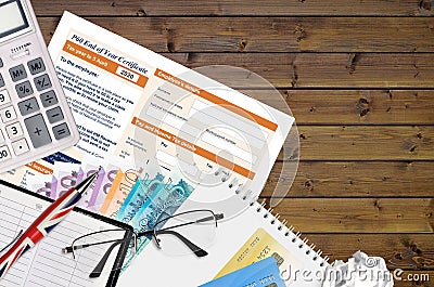 English Tax form P60 End of year certificate by HM revenue and customs lies on table with office items. HMRC paperwork and tax Editorial Stock Photo