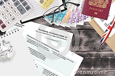 English Tax form sa108 Residence remittance basis etc from HM revenue and customs lies on table with office items. HMRC paperwork Editorial Stock Photo