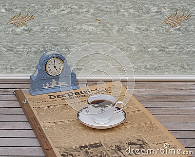 English teacup and saucer in front of a pale blue Wedgwood watch, Jasperware, on an old German daily newspaper Der Patriot Editorial Stock Photo