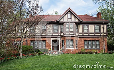 English Tudor Home with Red Spring Tulips Stock Photo