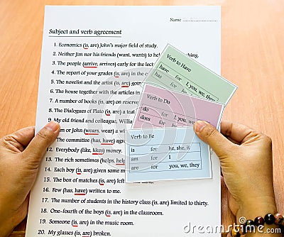 English verb cards in hand Stock Photo