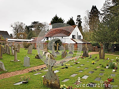 English Village Churchyard and Cottage Stock Photo