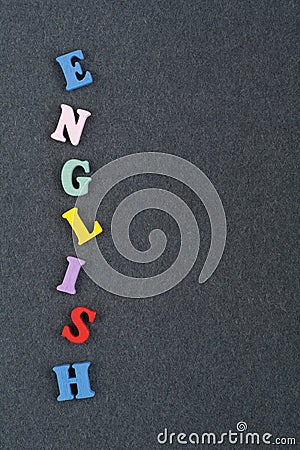 English word on black board background composed from colorful abc alphabet block wooden letters, copy space for ad text Stock Photo
