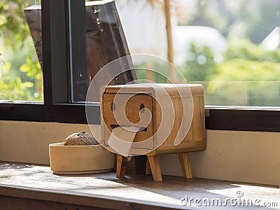 Natural Elegance: Wooden Tissue Box Adorned by Sunlit Window Stock Photo