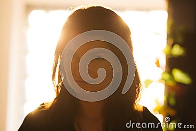 Enigmatic woman in sunset light Stock Photo
