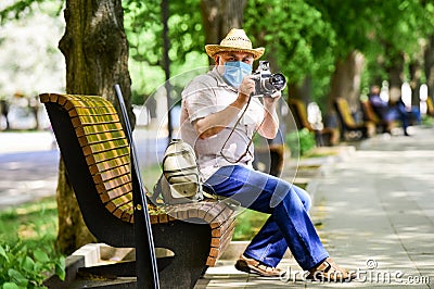 Enjoy the beauty. fear of illness. photographer with camera on bench. prohibition on visiting public places. senior man Stock Photo