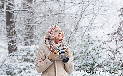 Enjoy beauty of snow scenery through photos. Woman photographer with professional camera. Enjoy enchanting paleness and Stock Photo