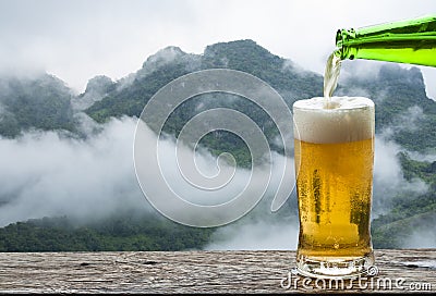 Enjoy beer with mountain landscape. Stock Photo