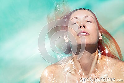 Enjoy the summer. Woman relaxing in the pool water Stock Photo