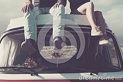 Young legs on e top of a vintage van in travel vacation life Stock Photo