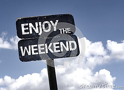 Enjoy the Weekend sign with clouds and sky background Stock Photo