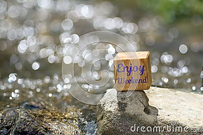 Enjoy weekend on wooden block Stock Photo