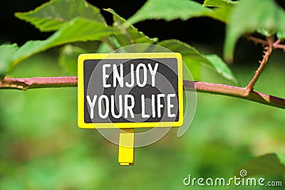 Enjoy your life text on board Stock Photo