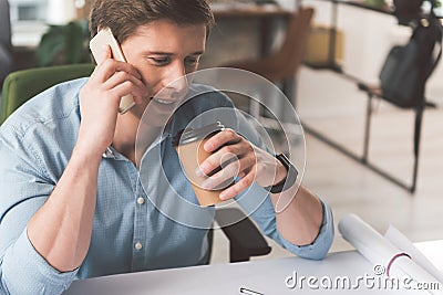 Joyful skillful guy is resting with coffee Stock Photo