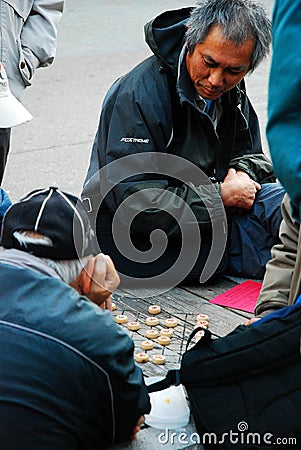 Enjoying a game of xiangqi Editorial Stock Photo