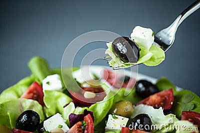Enjoying a healthy Greek salad Stock Photo