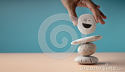 Enjoying Life Concept. Harmony and Positive Mind. Hand Setting White Natural Stone Stack to Balance. Balancing Body, Mind, Soul Stock Photo