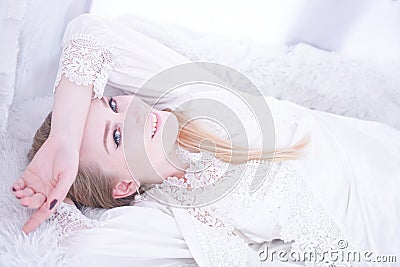 Attractive female in white lingerie relaxing at home on her windowsill Stock Photo