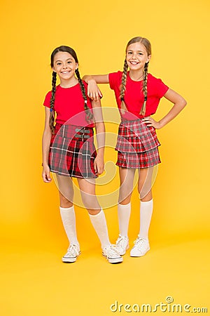 Enjoying playtime. childhood happiness. trendy school uniform. red fashion girls. english style fashion. happy little Stock Photo