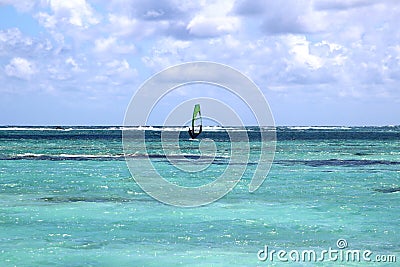 Enjoying windsurfing in the turquoise water of Indian ocean in solitude Stock Photo