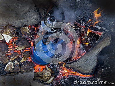 Enjoyment of camping, brewing tea, cooking mushrooms and wood fire in the camp Stock Photo