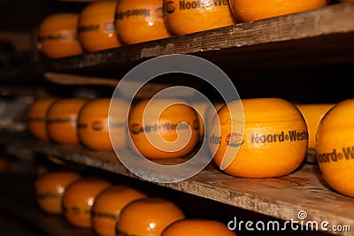 Enkhuizen, Netherlands, June 2022. Close up of a cheese warehouse. The cheeses are stacked on the shelf. Editorial Stock Photo