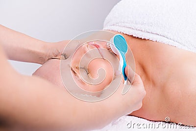 Enlarged photo of senior woman and face massage with cosmetic massager. Skin care, spa and beauty concept. Stock Photo