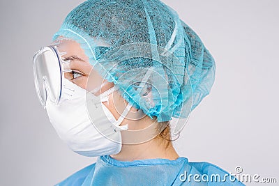 Enlarged profile photo. Doctor in a protective mask and medical goggles on gray background Stock Photo