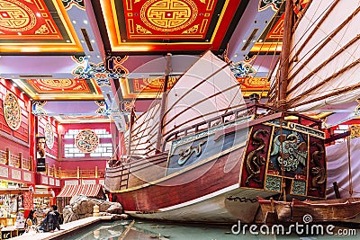 Enormous Chinese junk displayed in department store with colorful Chinese ceiling decorated with tourists in Dubai Editorial Stock Photo