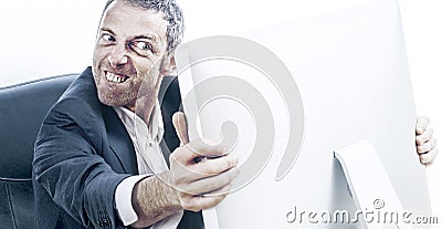 Enraged businessman with bulging eyes and teeth holding computer Stock Photo