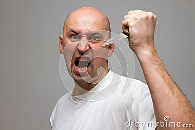 Enraged man with a knife in a murderous rage Stock Photo