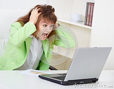 Enraged woman reads news in Internet Stock Photo