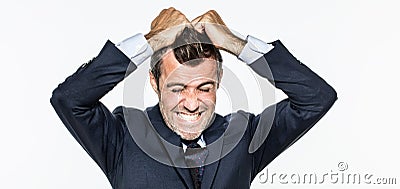 Enraged young businessman pulling his hair out for exasperation Stock Photo